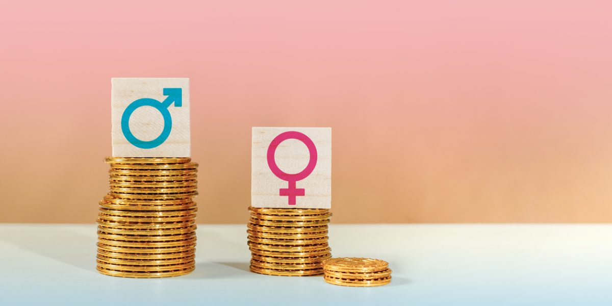 The symbols of male and female on piles of coins, gender pay equality concept